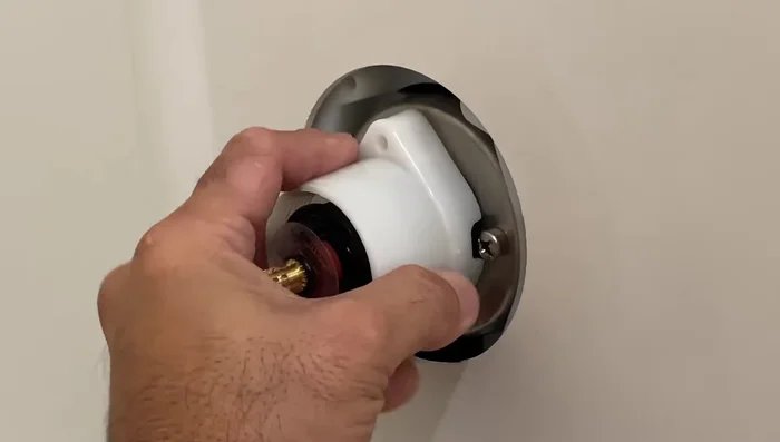 Place the plastic adapter and re-secure with the screws.