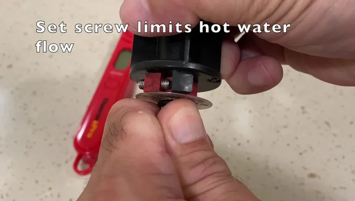 Run hot water and test temperature with thermometer. Adjust to your preference (115 degrees Fahrenheit is suggested).