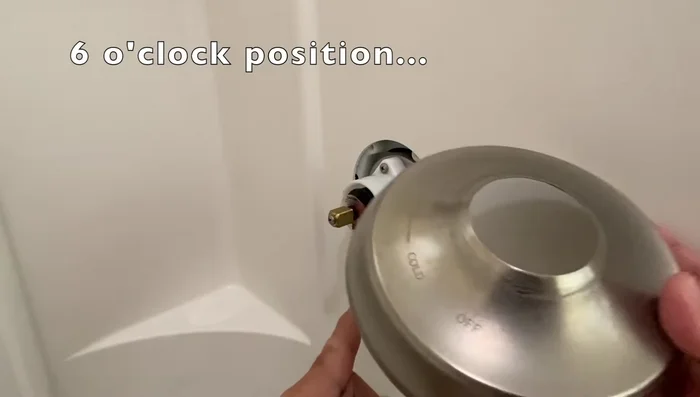 Note the notch on the valve trim and place it in the six o'clock position. Reinstall the handle and valve trim.