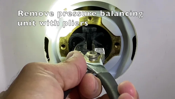 Pull out the pressure balancing unit with a pair of pliers.