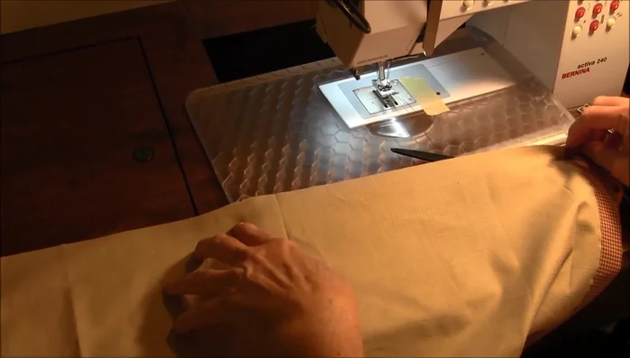 Sew the bottom hem: Press under 1/4 inch, then press and sew a 1.5-inch hem.