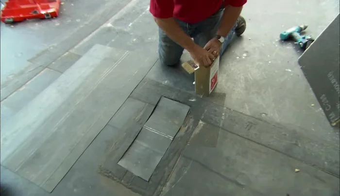 Apply rubber cement to the roof and half of the patch, let dry.