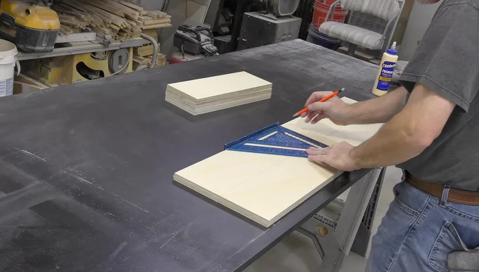 Layout for the cabinet body, using the cabinet bottom and spacer blocks to set the spacing for the finished ends.