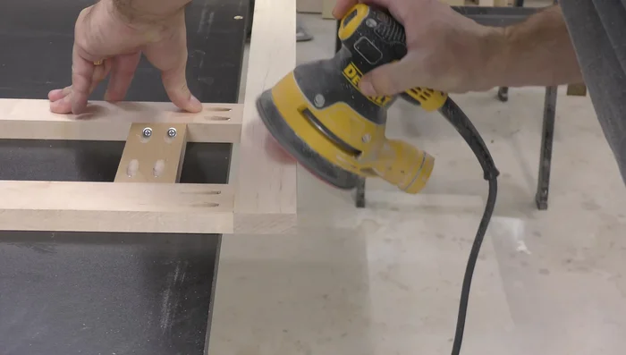 Sand the backside of the face frame and create micro bevels on the back of the finished end styles and bottom rails.