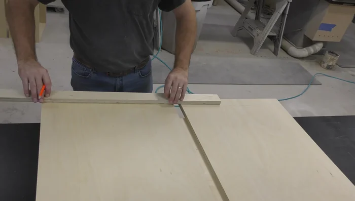 Glue and attach the face frame to the cabinet body. Use brads to secure it.