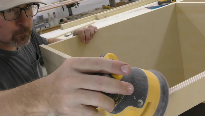 Glue and attach the face frame to the cabinet body. Use brads to secure it.