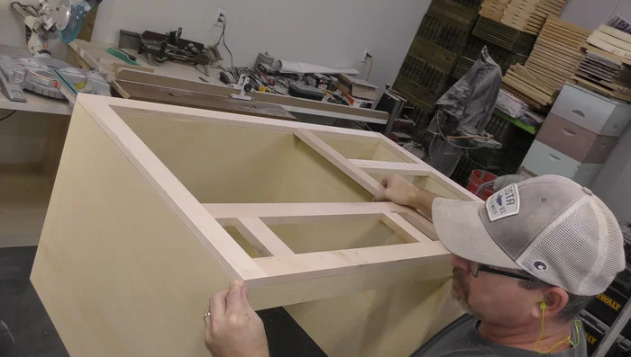 Glue and attach the face frame to the cabinet body. Use brads to secure it.