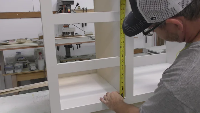 Install drawer fronts and pulls.