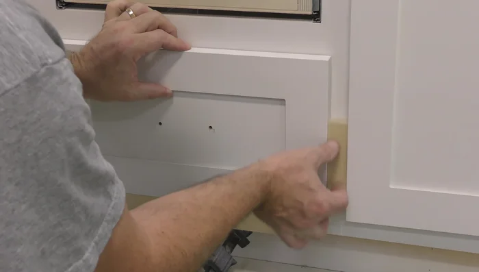 Install drawer fronts and pulls.