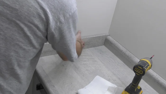 Install side splash and caulk seams.