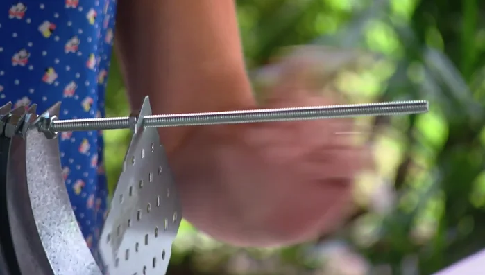 Add the top strap to form a spiral shape, secure with the final small nut.