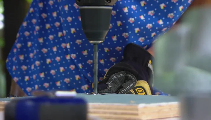 Drill holes at each end of the metal strips, slightly larger than the rod diameter.