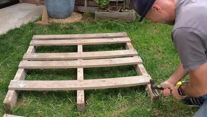 Reattach slats to both pallets.