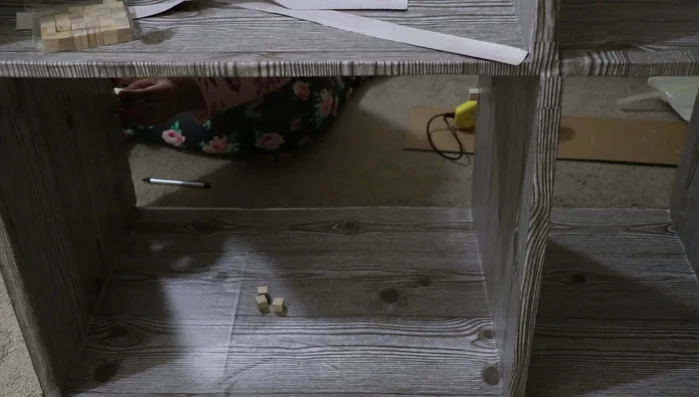 Add partitions (optional): Use wooden cubes or other materials to create dividers within the shelves.