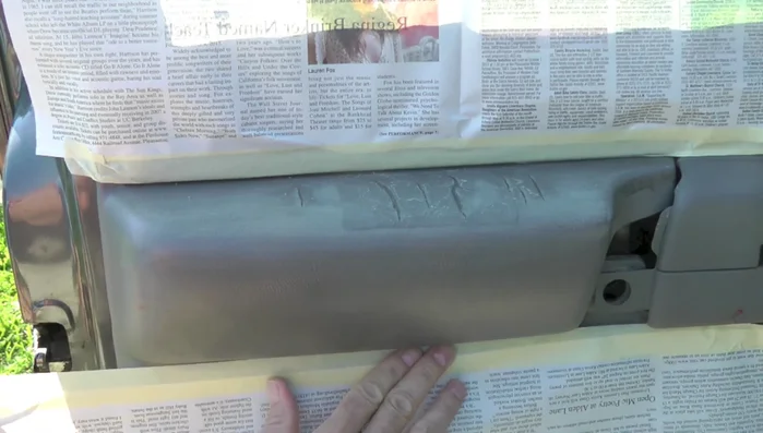 Mask off the surrounding area to protect it from adhesive spray.