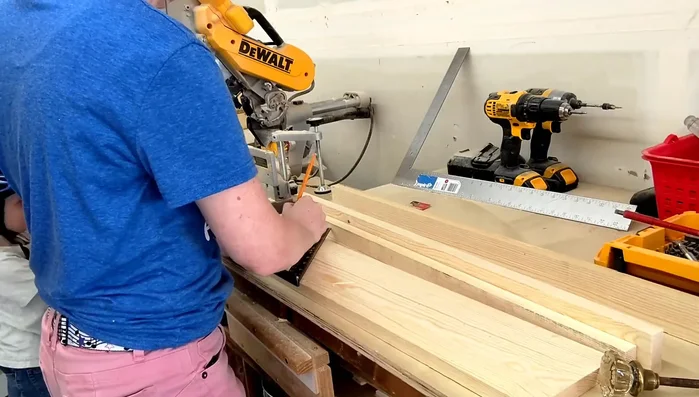 Mark and drill holes for knobs: Mark five lines for the knob placement (5 inches apart) and drill pilot holes with Forstner bit to match the bolt depth. Then drill all the way through using a bit matching the bolt size.