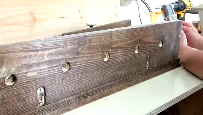 Attach the knobs: Screw in most of the knobs using the bolts. For knobs without suitable screw holes, use epoxy to secure them in place.