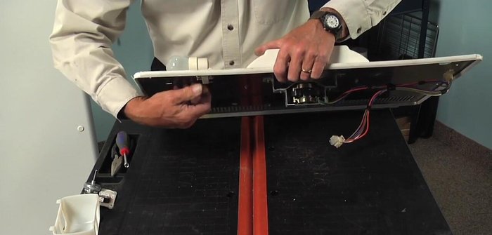 Remove the light bulb and socket by depressing the top tab and tilting it out.