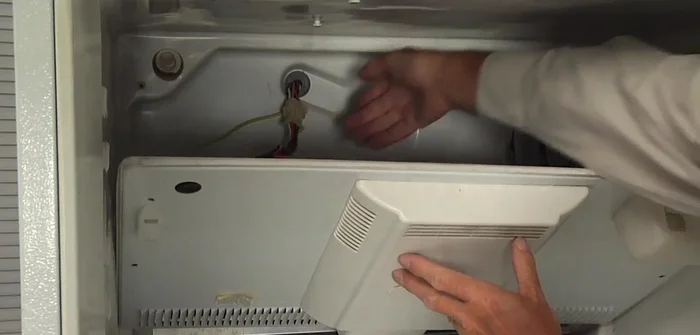 Disconnect the wires to the light bulb and the evaporator fan motor harness.