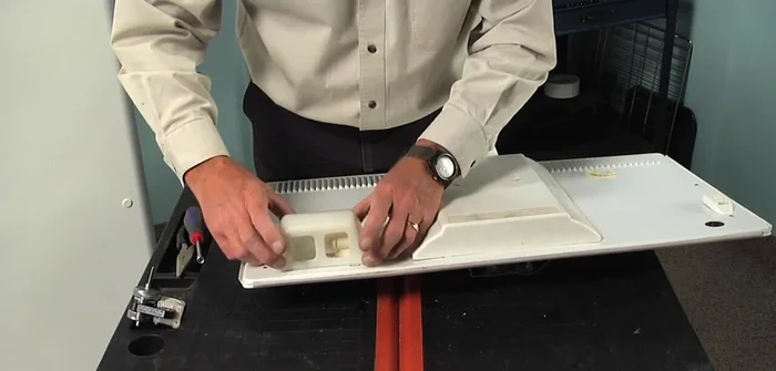 Remove the light bulb and socket by depressing the top tab and tilting it out.