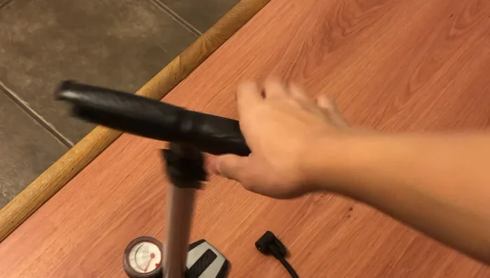 Insert the ball pin into the cork and connect it to the bike pump securely using clamps.