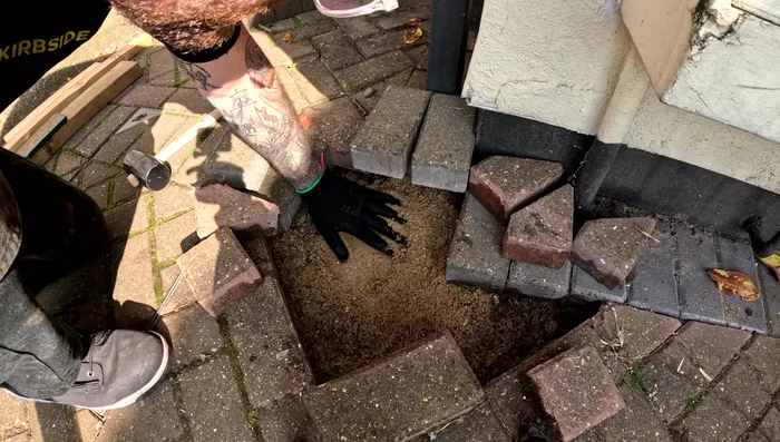 Level the sand; ensure the blocks sit a couple of millimeters higher than the surrounding level blocks once placed.