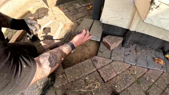 Level the sand; ensure the blocks sit a couple of millimeters higher than the surrounding level blocks once placed.