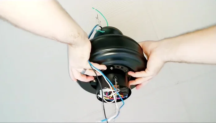 Secure the fan to the mounting bracket. Connect the ball-type mounting system provided with the fan, ensuring no wires are pinched.