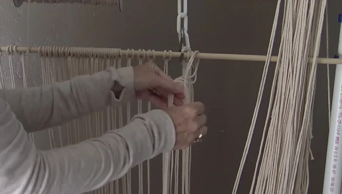 Attach cords to the temporary dowel, spacing them slightly over an inch apart.