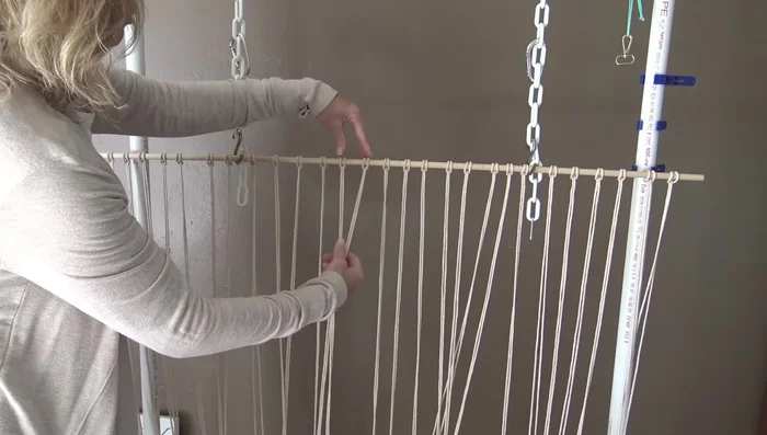 Use cardboard strips to maintain consistent 1-inch spacing between rows of square knots. Continue for approximately 39-40 inches.