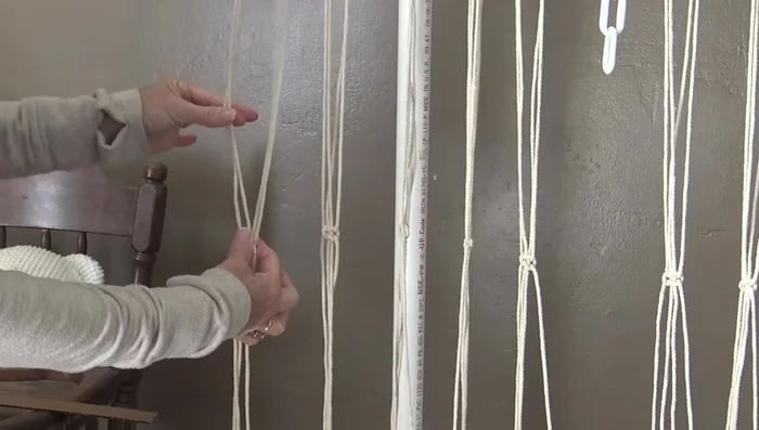 Use cardboard strips to maintain consistent 1-inch spacing between rows of square knots. Continue for approximately 39-40 inches.