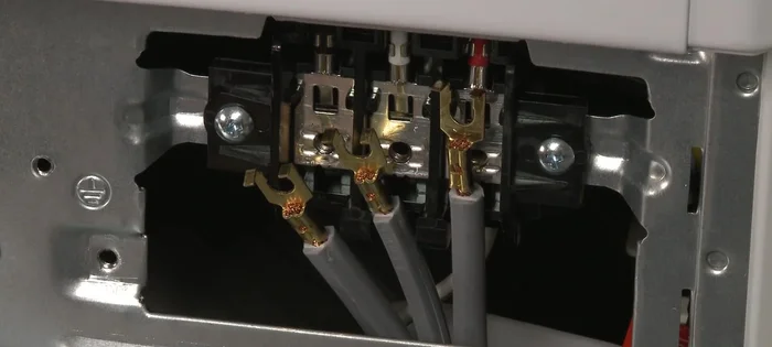 Tighten the strain relief screws to secure the power cord.