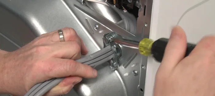 Tighten the strain relief screws to secure the power cord.