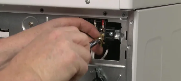Remove the screw to release the grounding connection.