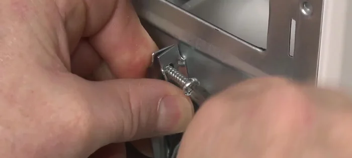 Remove the screws from the strain relief and pull the relief out of the rear panel.