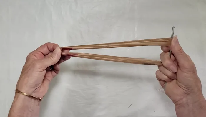 Flip the crochet hook and repeat the twisting process on the other end of the loop.