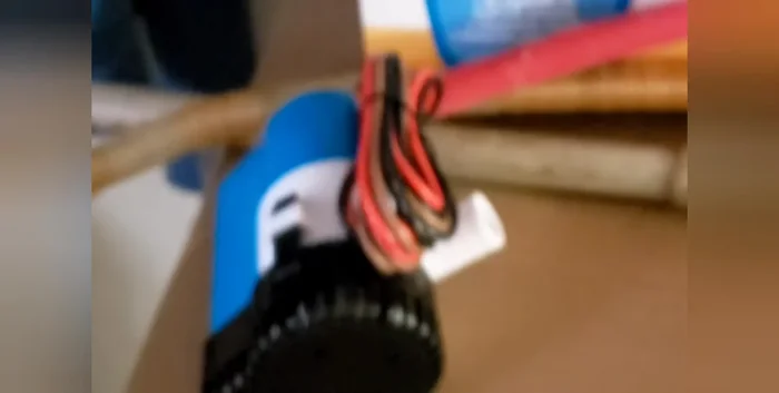 Fill a 5-gallon bucket with hot water. Submerge the end of the PEX pipe (connected to the bilge pump) in the bucket.