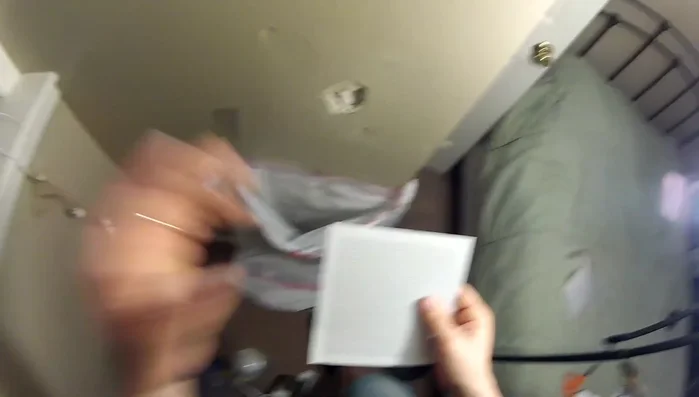 Apply a small amount of joint compound to the hole, especially for smaller holes, using a putty knife. This helps the patch adhere better.