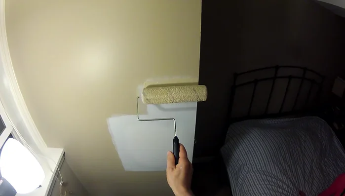 Apply at least two coats of paint, allowing each coat to dry completely, to match the surrounding wall.