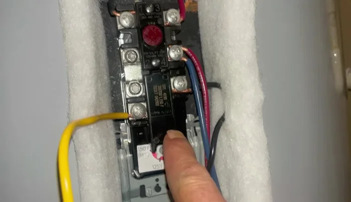 Set the temperature gauge on the thermostat to 120-125 degrees Fahrenheit.