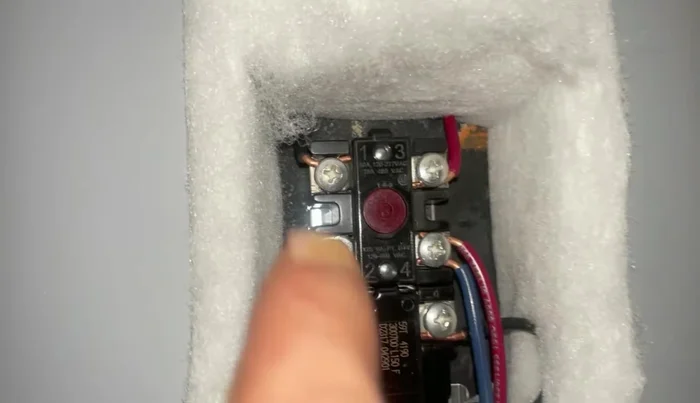 Set the temperature gauge on the thermostat to 120-125 degrees Fahrenheit.