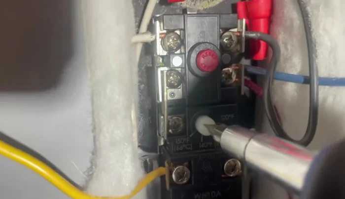 Set the temperature gauge on the thermostat to 120-125 degrees Fahrenheit.