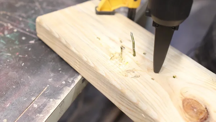 For bent nails, position the nail remover at an angle to straighten and remove the nail.