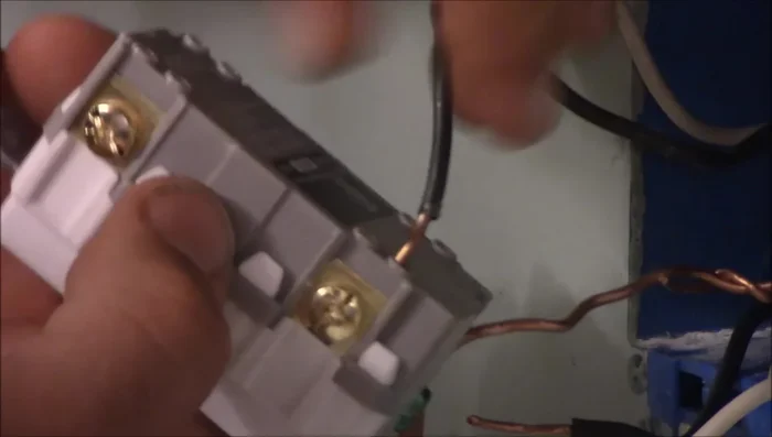 Connect the line and load wires to the GFCI outlet, ensuring hot wires go to the brass terminals and neutral wires to the silver terminals.