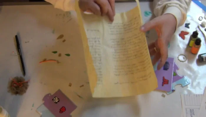 Apply gesso to the puzzle pieces to prepare the surface and prevent the paper color from showing through.