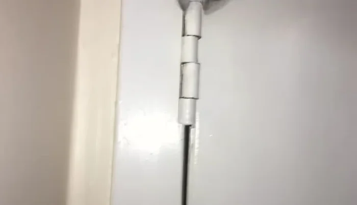 Adjust the hinge loops: Use the adjustable crescent wrench to carefully bend the door-side loops slightly to the right (or left, depending on door jamb location). Apply firm pressure; you may need both hands.