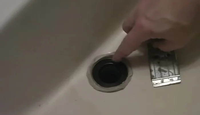 Remove excess plumber's putty.