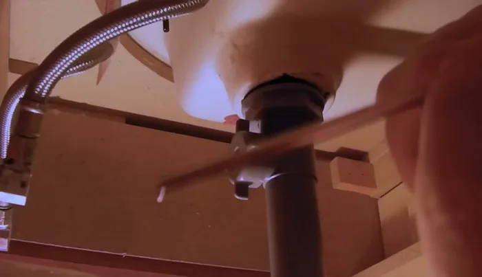 Reconnect the drain assembly under the sink, tightening all connections.