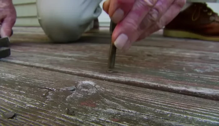 Reset protruding nails flush with the surface using a hammer and drift pin to avoid denting the wood.