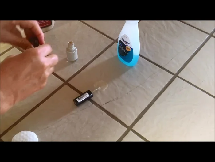 Apply the mixed nail polish over the dried wood glue, gently blending it into the surrounding tile. Work in small sections to ensure a natural blend.